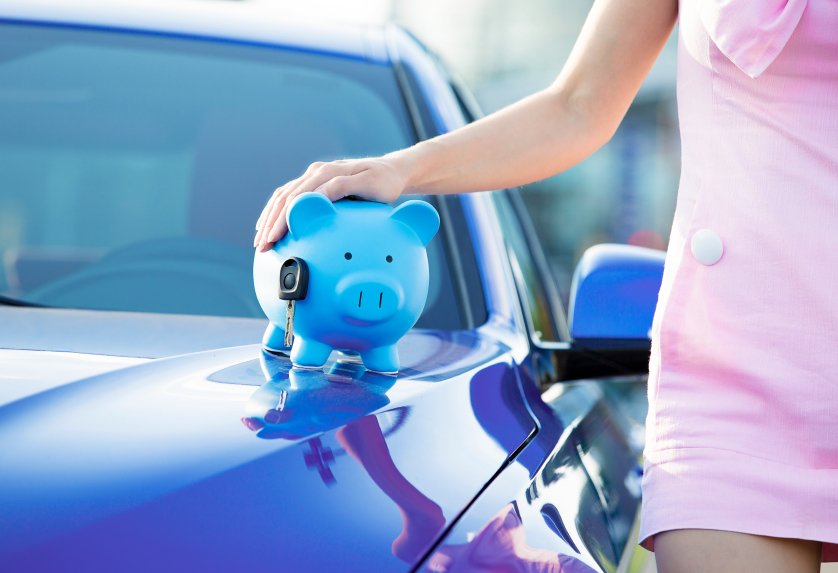 Cropped image woman customer, agent and new car, piggy bank, key on hood, isolated outside, outdoors. Dealership offering credit line, finance services. Lease, automobile purchase, financing concept